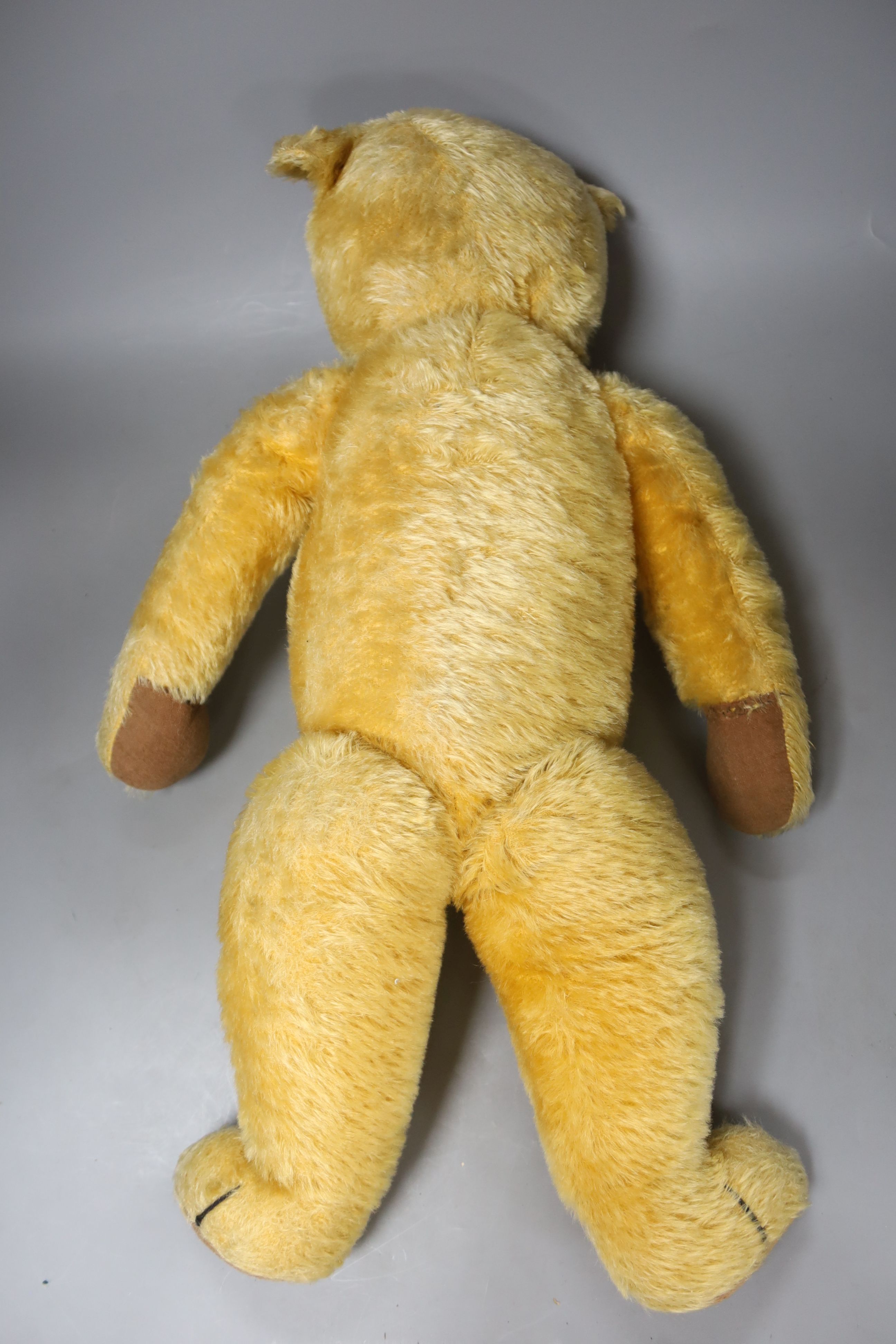 An early 20th century Chad Valley blonde plush teddy bear, length 58cm